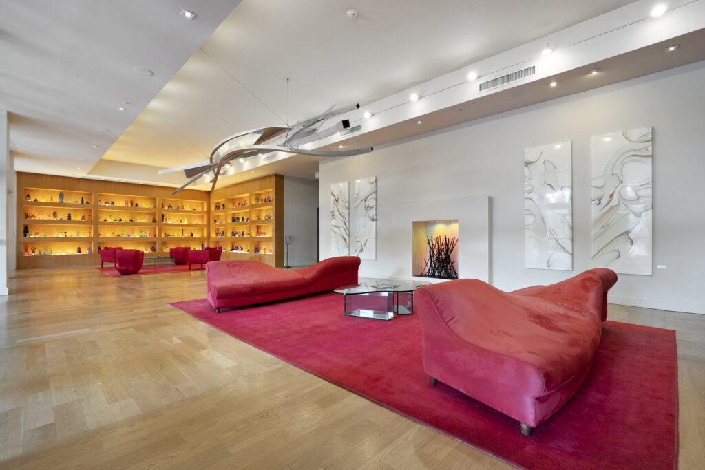 A living room with red couches and a fireplace.