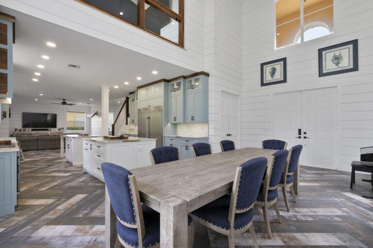 A large dining room table with blue chairs